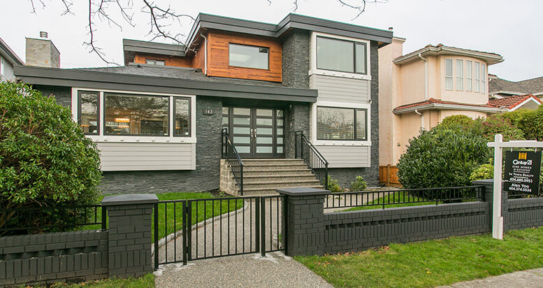 Modern renovated home with a gray facade and wooden accents