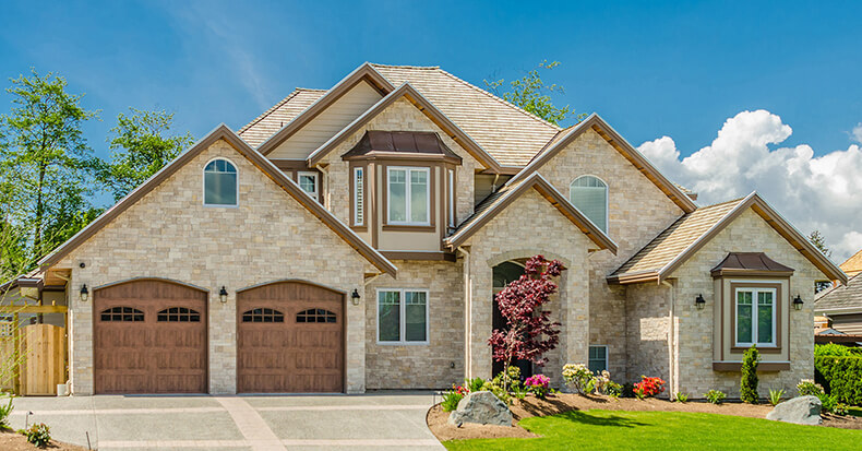 Suburban house with stone facade and a landscaped garden