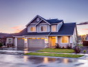 Suburban two-story house with double garage at twilight