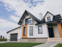 Contemporary two-story house with a dark roof and beige walls