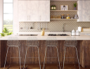 Stylish kitchen with geometric backsplash, modern bar stools, and open shelving